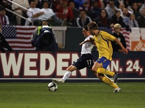 Swedish defender Adam Johansson (R) battles current Whitecap John Thorrington of the U.S. in a 2009 international friendly. (Victor Decolongon/Getty Images)
