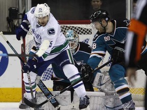 Andrew Ebbett scores the game-winning goal as he tips a Kevin Bieksa shot past San Jose Sharks goaltender Antti Niemi in overtime Wednesday night in San Jose. (Nhat V. Meyer/San Jose Mercury News/MCT)