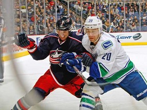 Chris Higgins goes into the corner against Blue Jackets' Marc Methot during Tuesday's game in Columbus. (Fred Squillante/Columbus Dispatch/MCT)