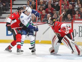 Craig Anderson and Chris Phillips of the Ottawa Senators defend against Ryan Kesler at Scotiabank Place on Saturday. (Andre Ringuette/Getty Images)