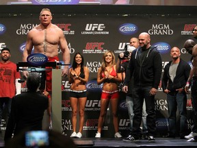Brock Lesnar on the scales at yesterday's UFC 141 weigh-ins as his opponent Alistair Overeem and a host of others look on. (photo courtesy of Josh Hedges / Zuffa LLC)