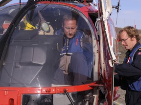 Defence Minister Peter MacKay prepares for take-off in 2009 on one of his many helicopter flights, thanks to taxpayers. - DEFENCE DEPARTMENT FILES