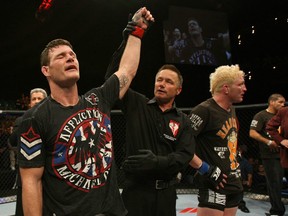 Michael Bisping's hand is raised in victory Saturday night at The Ultimate Fighter 14 Finale. (photo courtesy of Josh Hedges/Zuffa LLC/Zuffa LLC via Getty Images)