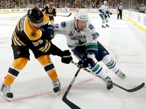 Victor Oreskovich fights for the puck with Boston's Johnny Boychuk in Game 6 of last June's Stanley Cup final.