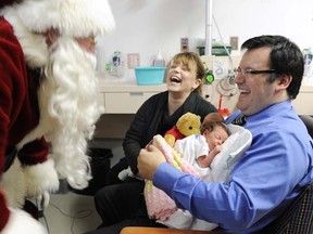 Santa Claus, played by Dal Richards, visits newborn twins Amelia and Nicholas with parents Anne and Frank Vassallo in the maternity centre at St. Paul's Hospital.