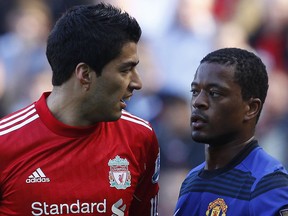 Luis Suarez (left) and Partice Evra we're getting up close and personal on October 15.