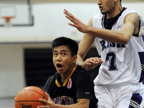 Vancouver College's Abu Khan (right) towers over Burnaby South's speedy guard Gino Pagbilao during Emerald 2012 semifinals on Friday, (Stuart Davis, PNG photo)