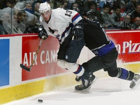 Artem Chubarov fights off Brad Norton's check in a 3-2 Canucks win over the Kings on Nov. 14, 2002, Game 1 of a 385-game-and-counting sellout streak at GM Place/Rogers Arena.