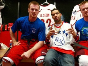 Drake centres Daniel Sedin (left) and Henrik Sedin (right, wearing a Rick Rypien memorial shirt to promote mindchekc.ca, a site set up to help those dealing with depression and other mental-health issues).