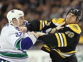 Nathan Horton (right) and Dale Weise scrap in the first period on Saturday at TD Garden in Boston. (Elsa/Getty Images)