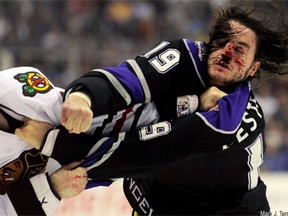 FILE - In this Nov. 27, 2010, file photo, Chicago Blackhawks defenseman John Scott, left, and Los Angeles Kings right wing Kevin Westgarth fight during the second period of their NHL hockey game in Los Angeles. This image is one in a portfolio of 12 by AP photographer Mark J. Terrill which won the AP's Thomas V. diLustro  award for best portfolio in the annual contest for AP staffers judged by the Associated Press Sports Editors at their winter meeting.  (AP Photo/Mark J. Terrill, File)