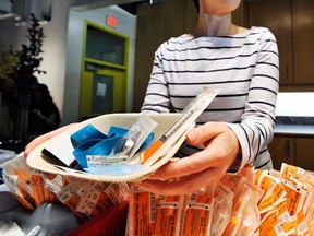 Nurse Sammy Mullally displays a kit  complete with a syringe for drug addicts to use at the Insite injection facility in Vancouver. Some critics of "harm reduction" programs such as Insite are growing tired that their views are being ignored. (Ian Smith/PNG FILES)