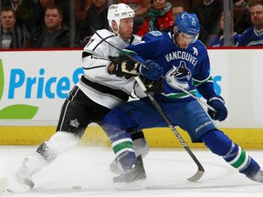 Ryan Kesler fights for the puck with Rob Scuderi of the Kings on Tuesday night.
