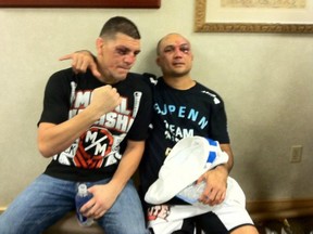 BJ Penn isn't happy with the man he's sitting next to in the this picture, Nick Diaz. (photo courtesy of BJ Penn's Twitter)
