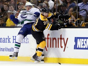 Chris Tanev and Daniel Paille collide in Game 6 of the Stanley Cup final last spring in Boston.