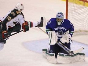 Roberto Luongo makes a save against Devin Setoguchi during the Canucks' 3-0 win over the Minnesota Wild on Wednesday night at Rogers Arena. (Mark van Manen/PNG)