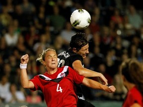 Canada's Carmelina Moscato and Abby Wambach of the U.S. do batttle at Jeld-Wen Field in Portland, Oregon last September. Getty Images photo.