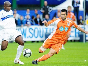Etienne Barbara (R) in action for Carolina against former Whitecaps defender Nelson Akwari in the division two days.