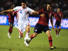 Carlos Bocanegra (R) of the U.S. battles Costa Rica's Daniel Colindres. (ROBYN BECK/AFP/Getty Images)