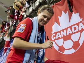 Christine Sinclair signs autographs at the CONCACAF Olympic qualifying tournament. (Photo by Rich Lam/Getty Images)