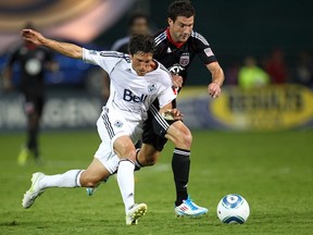 John Thorrington battles Chris Pontius of D.C. United while playing for the Vancouver Whitecaps. (Ned Dishman/Getty Images)