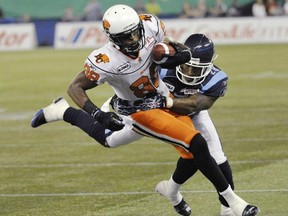 The Toronto Argonauts' Byron Parker tackles the Lions' Akeem Foster during a 2011 game in Toronto.