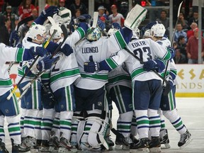 DETROIT, MI - FEBRUARY 23:  The Vancoucer Canucks celebrate their shootout win ending the Detroit Red Wings 23 game home winning streak after an NHL game at Joe Louis Arena on February 23, 2012 in Detroit, Michigan.  Vancouver wins 4-3 in shootout. (Photo by Dave Reginek/NHLI via Getty Images)