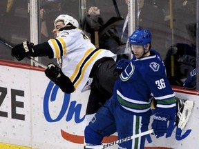 It was one year ago that Jannik Hansen dealt with Boston's Tomas Kaberle along the boards in Vancouver. Will Sami Pahlsson's addition to Hansen's line get the Dane back to his feisty ways? Getty Images file photo.