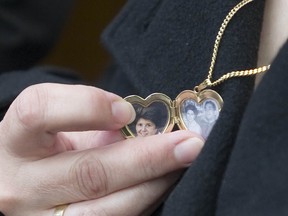 Giuseppina Osterman shows a locket that she wears which contains a photo of her mother, Maria Catroppa.  (Ward Perrin / PNG)