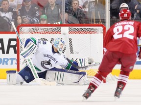 Cory Schneider makes a glove save on a shot from the Phoenix Coyotes during Tuesday's game in Glendale, Ariz. The Coyotes defeated the Canucks 2-1 in a shootout. (Christian Petersen/Getty Images)