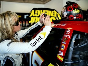 Miss Sprint Cup, Kristen Beat, snaps a picture of Clint Bowyer's helmet Friday during preparations for Sunday's Daytona 500. Getty Images photo.