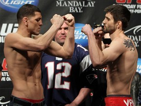 LAS VEGAS, NV - FEBRUARY 03: (L-R) Welterweight opponents Nick Diaz and Carlos Condit face off after weighing in during the UFC 143 official weigh in at Mandalay Bay Events Center on February 3, 2012 in Las Vegas, Nevada.|2:55:8 (Photo by Josh Hedges/Zuffa LLC/Zuffa LLC via Getty Images)