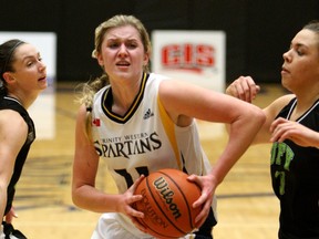 Trinity Western's Holly Strom drives past a pair of Fraser Valley defenders during CIS action Thursday at the Langley Events Centre. (Scott Stewart, TWU athletics)