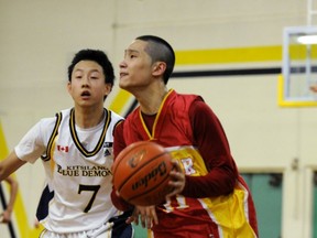 Kitsilano's Justin Sze pursues Tupper's Daniel Kim during Vancouver City championship final played Friday at Prince of Wales. (Stuart Davis, PNG)