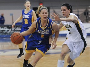 UBC Thunderbirds guard Kristen Hughes (left) drives by Alberta's Jill Verhesen during Saturday's series-clinching win at War. (Jason Payne, PNG photo)