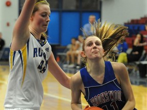 Brookswood Bobcats' point guard Luca Schmidt drive past Allison Patterson of Handsworth during the 2011 BC Triple A basketball championships last March in North Vancouver. (PNG photo)