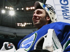 VANCOUVER — Roberto Luongo cracks a smile during a break in a Jan. 21 matchup against San Jose. The Canucks starter faces Detroit on Thursday. (Photo by Jeff Vinnick/NHLI via Getty Images).