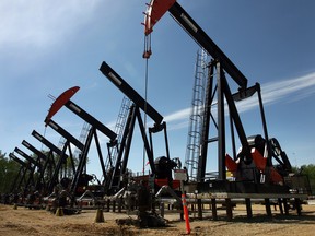 Pumpjacks pull bitumen from beneath the boreal forest at the Shell oilsands plant near Peace River. The oil sands are too deep to be mined, so steam is pumped underground to melt the oil out of the sand 800 metres below the surface. (CALGARY HERALD FILES)