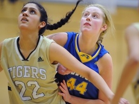 Handsworth Royals’ Allison Patterson battles in the paint with York House Tigers’ Preety Nijjar. Patterson has come back from a badly injured ankle to help her team into the B.C. Triple A championships set to begin Wednesday in North Vancouver. (Photo – Blair Shier, Handsworth athletics)