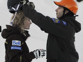 Pierre-Alexandre Rousseau of the Canadian National Freestyle ski team adjusts the helmet of teammate Kristi Richards during a training session on Cypress Mountain in 2009. (Gerry Kahrmann/PNG FILES)