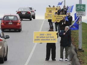 Teachers took to the bridges, including the Dinsmore bridge in Richmond on Saturday, Jan. 28, to mark the 10th anniversary the passage of Bills 27 and 28, two laws found last year to be unconstitutional in court that limited how teacher contract bargaining. (Jason Payne/ PNG FILES)