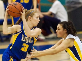 UBC's Tori Spangehl (left) has her drive guarded by Victoria's Allison Mulock during CIS regular season finale for both teams Friday in Victoria. (Times-Colonist photo)