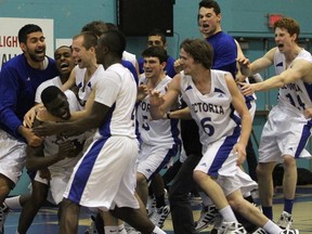 Victoria Vikes players congratulate Terrell Evans after the Las Vegas native hit the winning shot at the buzzer in a 90-88 stunner over the Calgary Dinos. (Adrian Lam, Times-Colonist)