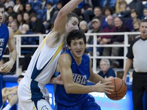 UBC Thunderbirds' Nathan Yu (right) drives past TWU's Calvin Westbrook earlier this season at War Gym. (Richard Lam, UBC athletics)