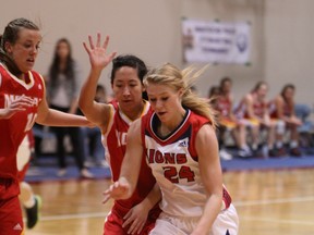 Yale senior Jessica Collins drives past arch-rival W.J. Mouat. The Lions placed third at the Fraser Valley championship and punched their ticket to Cap U. (Eric Arksey, Vibrant Photos)