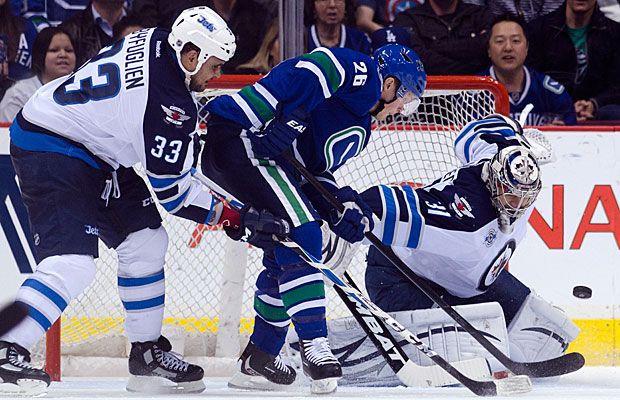 Goalie Ondrej Pavelec the Winnipeg Jets makes a save as the Canucks' Sami Pahlsson and Winnipeg's Dustin Byfuglien battle for position during Thursday's game at Rogers Arena. (Richard Lam/Getty Images)