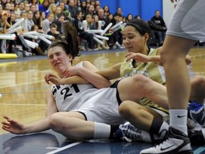 South Kam's Emma Wolfram (left) as she takes a hard tumble to the court with York House's Carmalitta Robertson during BC girls AAA final Saturday at Capilano University. (Les Bazso, PNG)