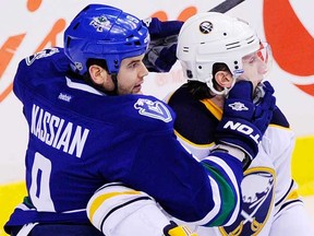 Zack Kassian gets a grip on Christian Erhoff during Saturday night's game at Rogers Arena. (Gerry Kahrmann/PNG)