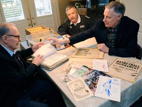 Bill Popowich (left), John Buis (centre) and Ken Winslade sift through the history of the B.C. boys high school basketball championships. (Ric Ernst, PNG)