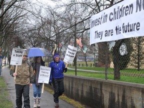 Striking teachers carry signs around Sir Guy Carleton Elementary on the  first day of their walkout on March 5. (Wayne Leidenfrost/PNG)